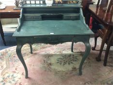 A green three drawer dressing table.