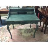 A green three drawer dressing table.