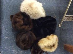A box containing fur hats and stoles.