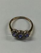 A sapphire and diamond triple cluster ring in 9 ca