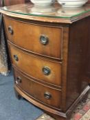 A mahogany bow front chest of four drawers.