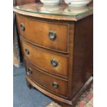 A mahogany bow front chest of four drawers.