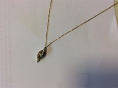 A small 18 carat gold diamond single stone pendant