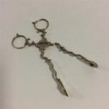 A pair of Georgian silver scissor action sugar ton