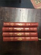 A set of four leather bound Voltaire books.