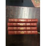 A set of four leather bound Voltaire books.