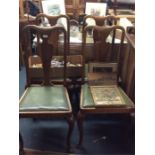 A set of four Queen Anne style dining chairs.