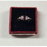An amethyst and gold seven stone ring in claw moun