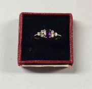 An amethyst and gold seven stone ring in claw moun
