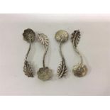 A good set of four cast spoons with floral bowl an