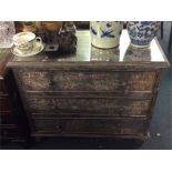 An unusual glass mounted chest of three drawers.