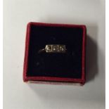 A small diamond three stone ring in 18 carat gold.