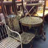 A metal garden table and two matching chairs.
