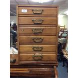 A mahogany miniature chest of six drawers.