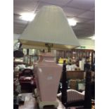A pair of large pink lamps and shades.