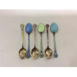 A set of six enamel teaspoons with silver gilt bow