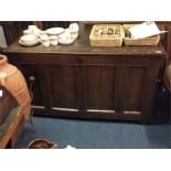 An Antique oak coffer with hinged top.