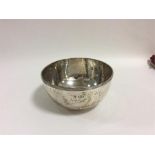 A heavy silver sugar bowl with textured design. Sh