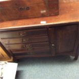 A mahogany music cabinet on bracket feet.