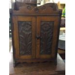 A small oak smoker's cabinet with fitted interior.