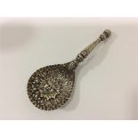 An unusual silver sifter spoon in the form of a fa