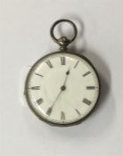 A small silver fob watch with gold hinges.