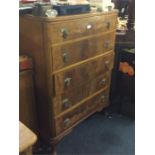 A walnut chest of five drawers.