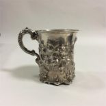 A silver christening cup with scroll decoration. L