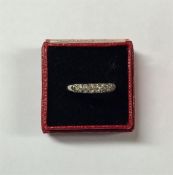 A three row diamond half eternity ring in claw mou