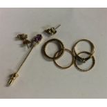 A collection of small gold rings and earrings.