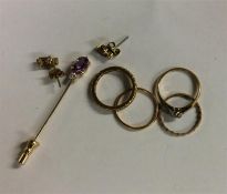 A collection of small gold rings and earrings.