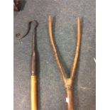 An old shepherd's crook together with a pick fork.