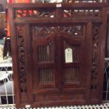 A hardwood carved wall bracket inset with mirror.