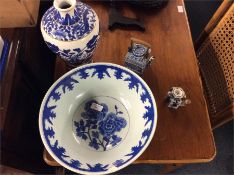 An Oriental blue and white bowl, vase and teapot.