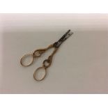 A pair of Antique gold scissors. The handles mount