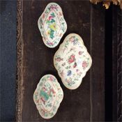 A set of three Oriental dishes inset with flowers.