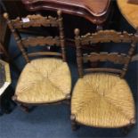 A pair of cane carver chairs.