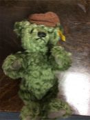 Steiff: A green teddy bear with cap numbered 65462