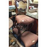 A set of three rosewood hoop backed dining chairs.