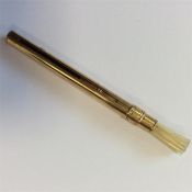 A small gold unusual pen / brush.