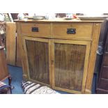 A pine two door side cabinet.