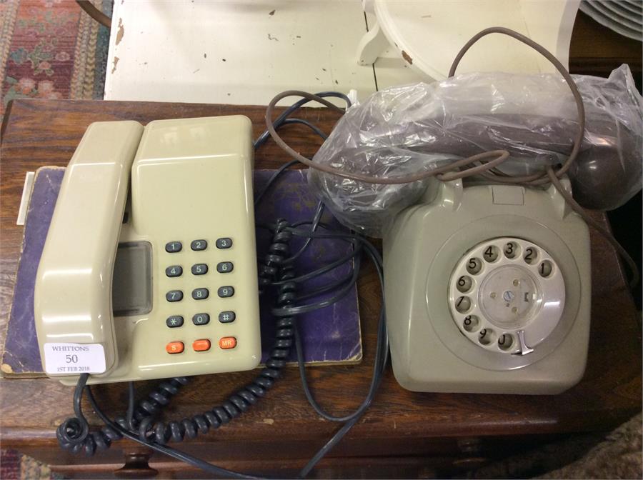 An old Bakelite telephone together with a press-bu