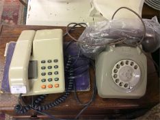 An old Bakelite telephone together with a press-bu