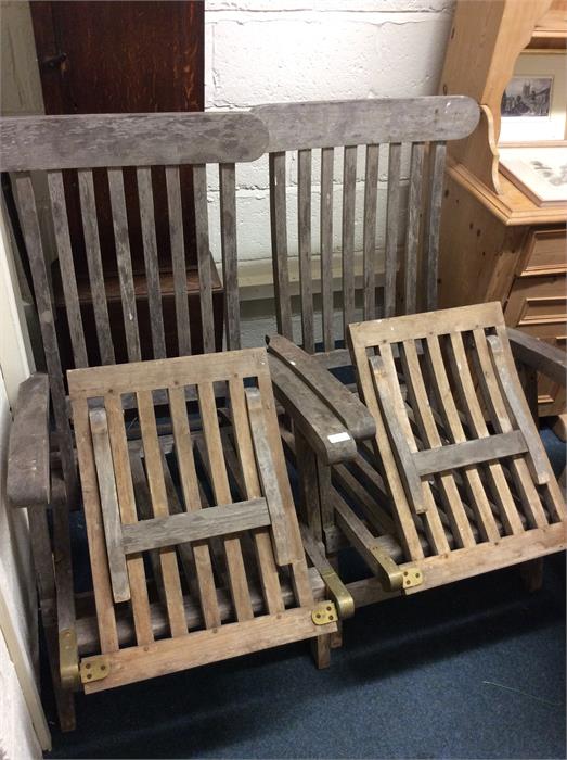 A pair of good teak garden chairs.