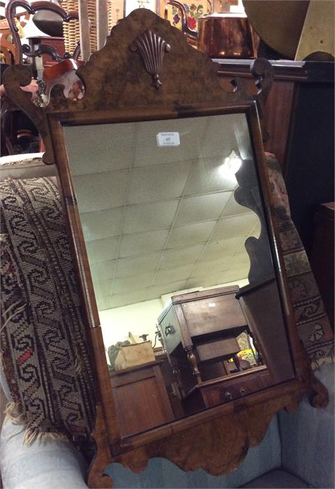 A walnut framed mirror with bevel edge.