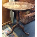 An oak tilt top occasional table on turned support