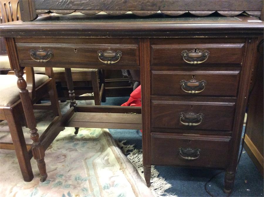 A mahogany Edwardian four drawer desk.