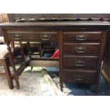 A mahogany Edwardian four drawer desk.