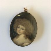 An Antique miniature of a lady with wavy hair and