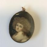 An Antique miniature of a lady with wavy hair and